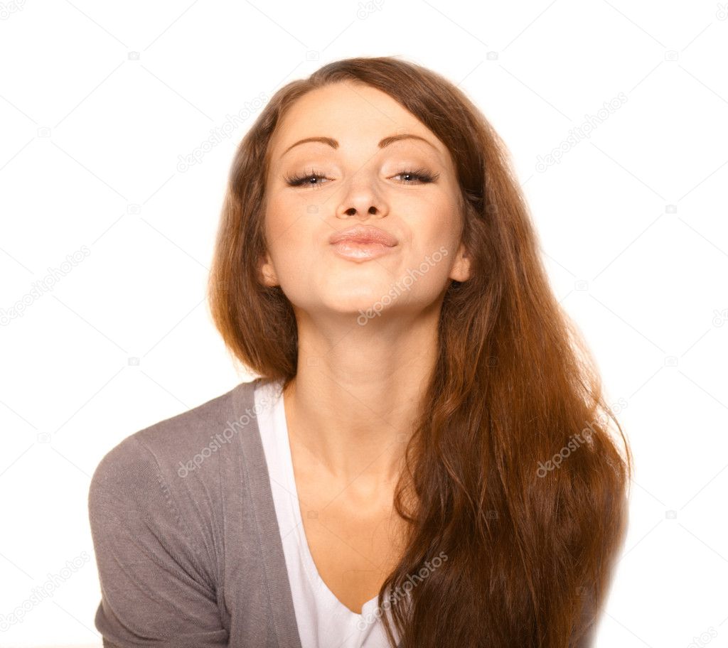 Closeup of flirtatious young woman pouting over white background