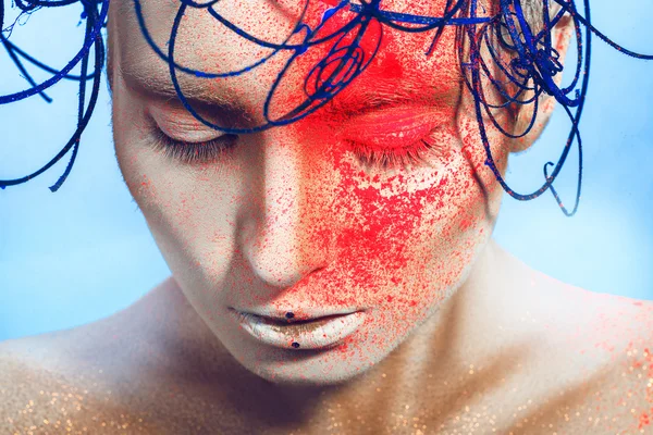 Horizontal portrait of sexy woman with neon powder on face in st