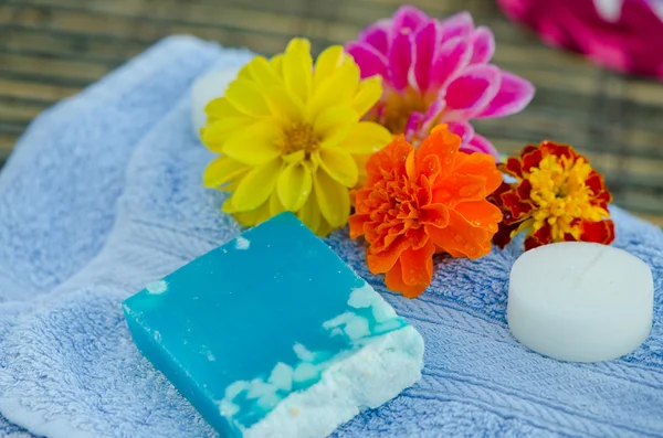 Spa and wellness setting with natural herbs soap and towel.