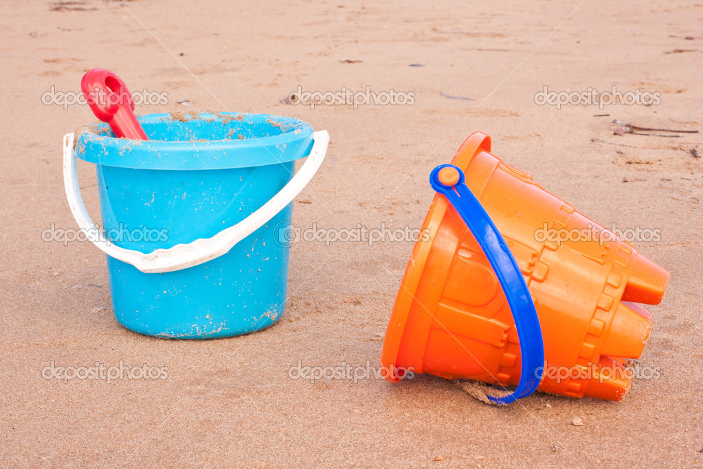 Kids plastic beach buckets with spade — Stock Photo © sdenness 12742363