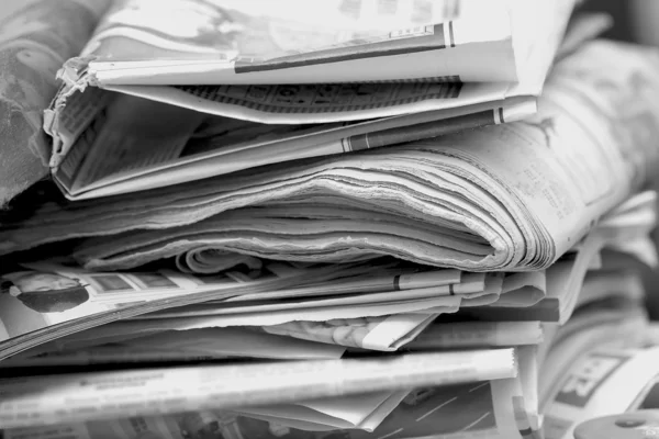 A mess of Newspapers in black and white