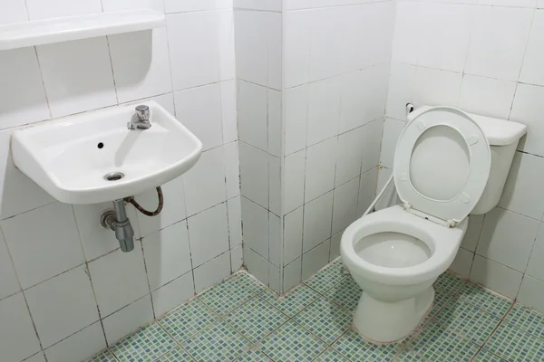 Toilet and white tile in home