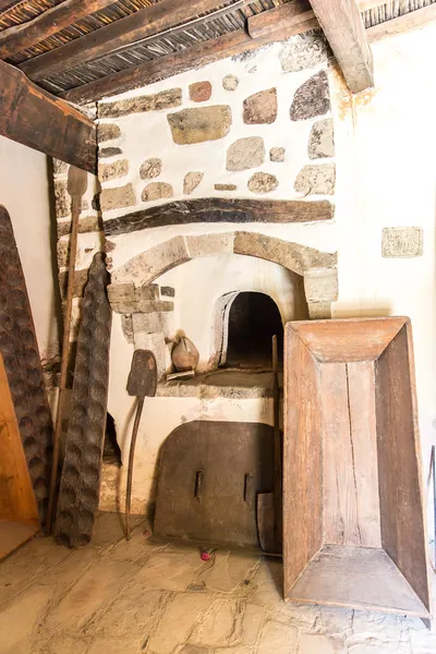 Oven-forged iron and ceramics in Museum with artifacts of ancient Greek pottery and clay in monastery in Messara Valley Crete, Greece