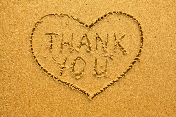 Texture of sand: the inscription inside the heart of Thank You.