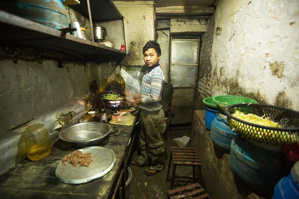 Unidentified boy from poorer area working in the kitchen dining room