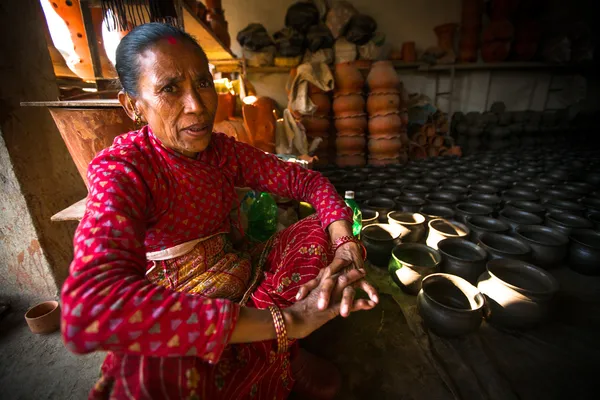 Unidentified Nepalese woman working in the his pottery workshop