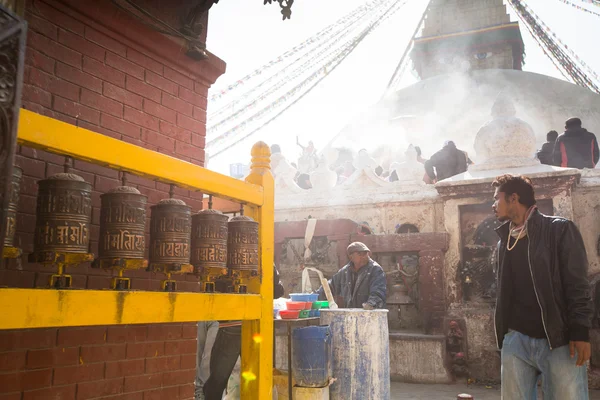 Unidentified man sell cement for donations for repairs near stupa Boudhanath