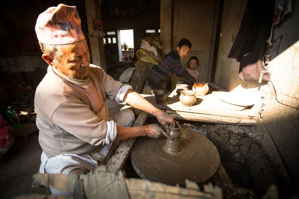 Unidentified Nepalese man working in the his pottery workshop