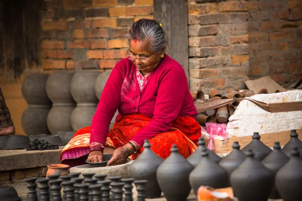 Nepalese man in pottery workshop
