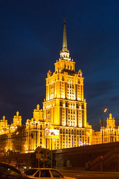 View of Hotel Ukraine on Embankment of the Moskva River at night in Moscow, Russia