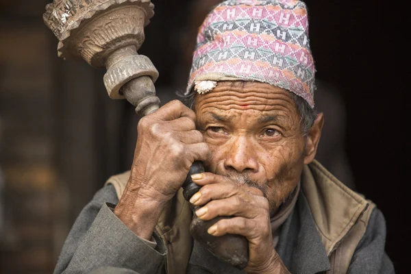 Nepalese man smokes on the street.