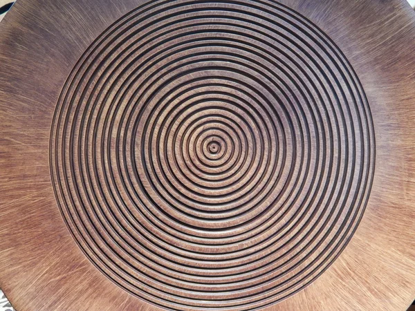 Circles carved in a wooden plate.