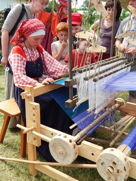 Folk crafts. A weaver. The Fourth International Historical Festival \