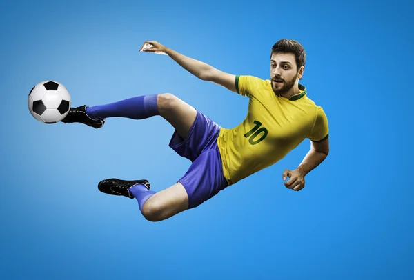 Brazilian soccer player in the jump kicks the ball