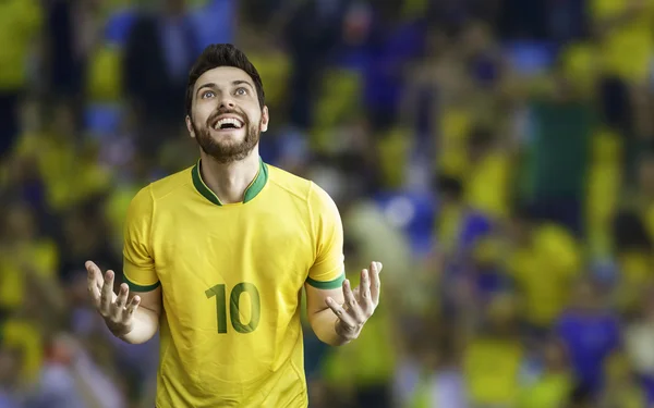 Brazilian soccer player celebrates with the fans on the stadium