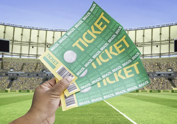 Hand holds a homemade soccer tickets in the stadium - Brazil