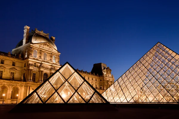 Louvre Pyramid shines at dusk