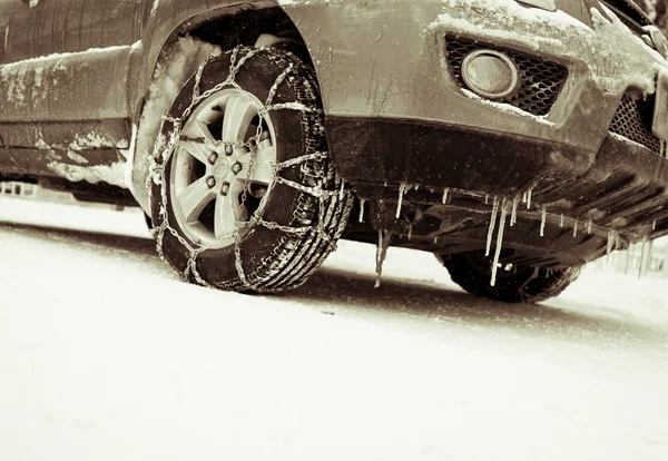 The car in the snow, tire mounted snow chains