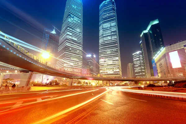 The light trails on the modern building background in shanghai china.