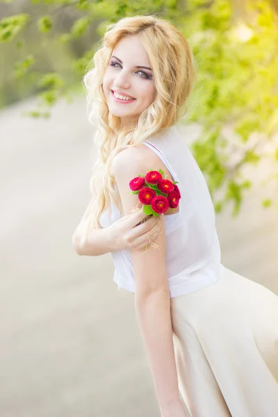 Portrait of a beautiful young blonde woman on a sunny summer day