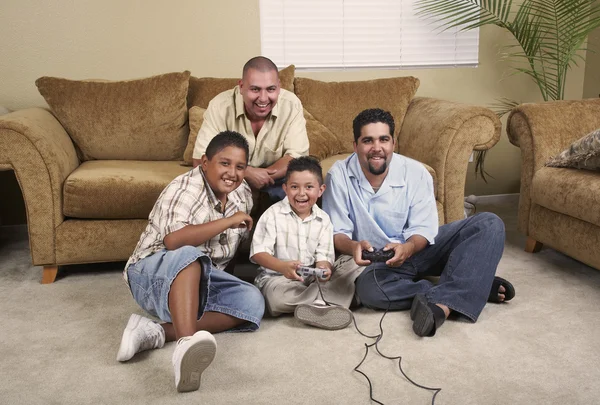 Multi-generational Hispanic male family members playing video games