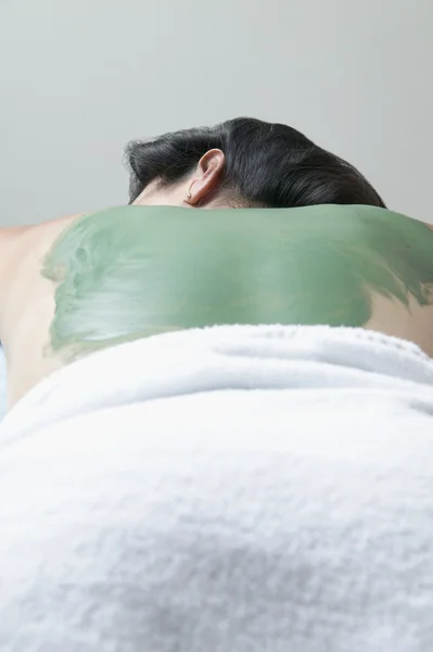 Woman\'s back covered with mud