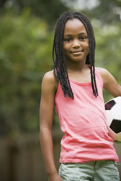 African girl holding soccer ball