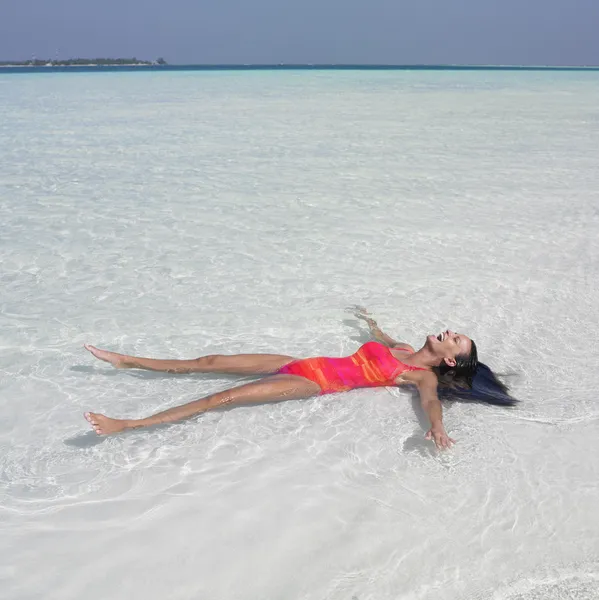 Young woman floating in ocean