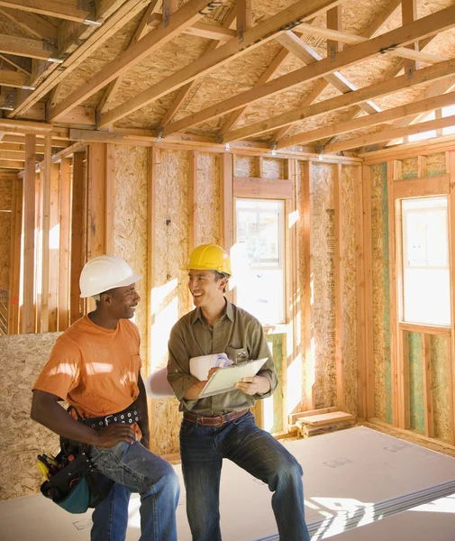 Two construction workers inside construction site