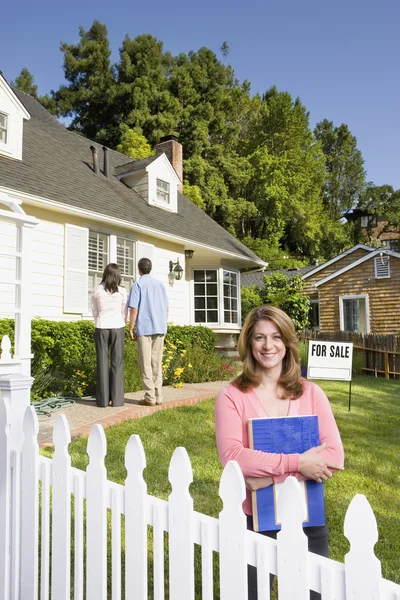 Couple looking at house with real estate agent