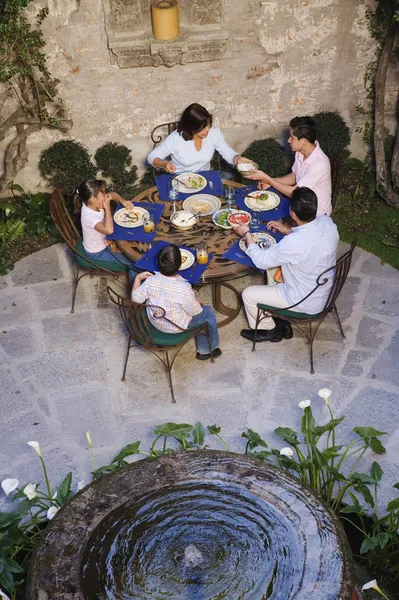 Hispanic family eating at outdoor restaurant