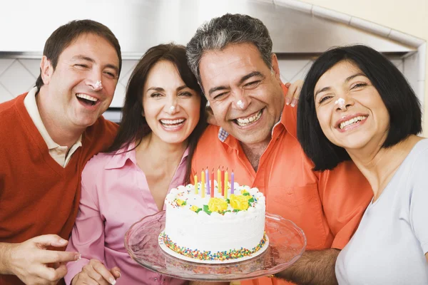 Middle-aged man celebrating birthday with friends