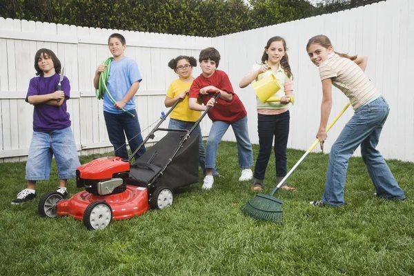 Multi-ethnic children doing yard work