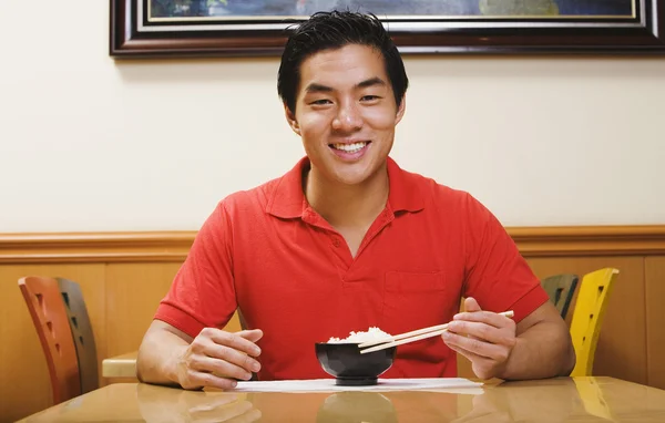 Portrait of Asian man eating rice