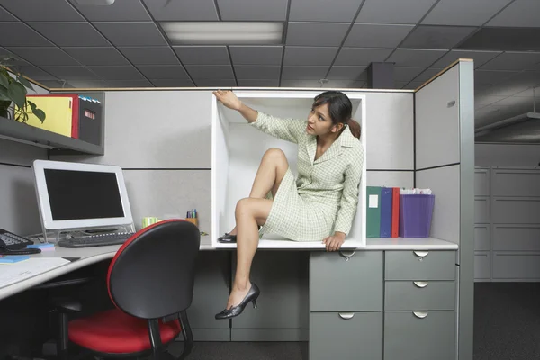 Businesswoman exiting office cubicle