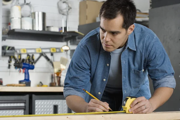 Carpenter making marks on wood