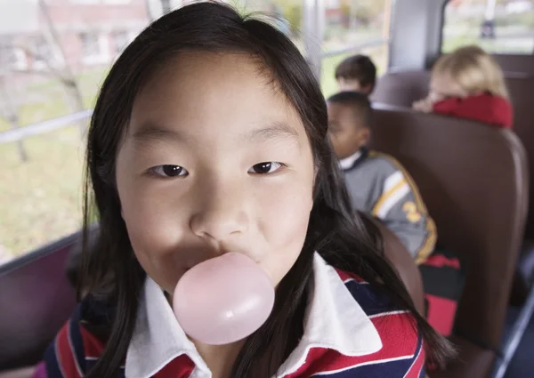 Close up portrait of girl blowing bubble