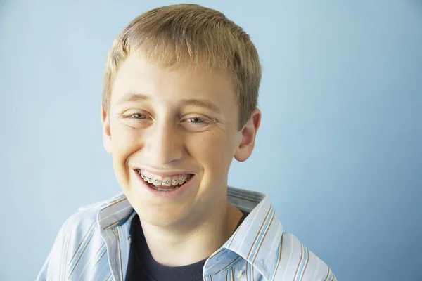 Teenaged boy smiling with braces