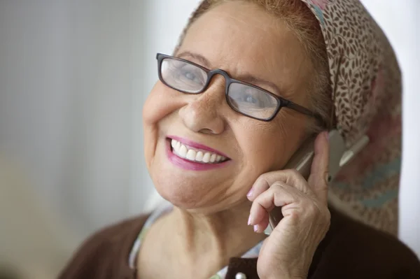 Elderly woman talking on cell phone