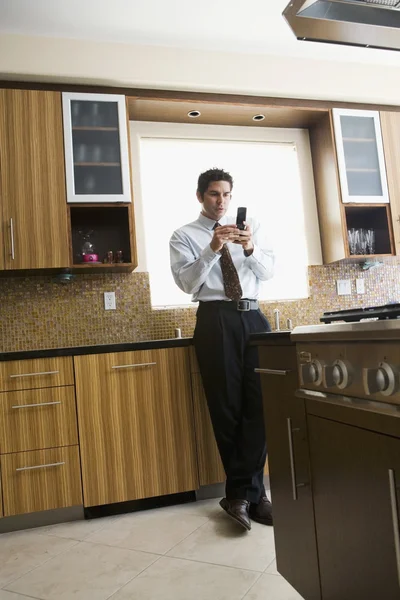 Hispanic businessman looking at cell phone