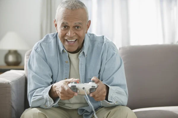 Senior man playing video game