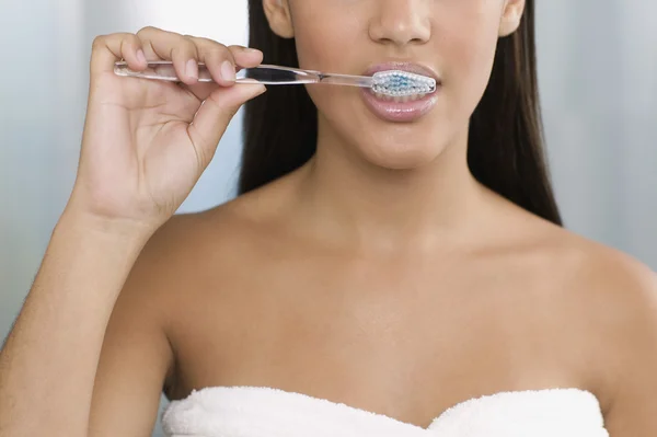 Young woman brushing her teeth