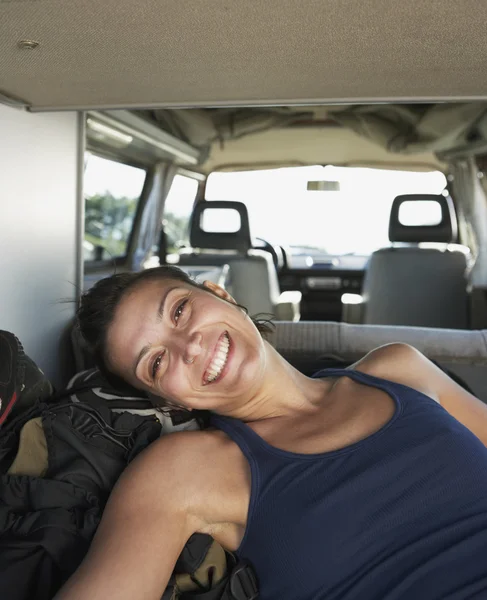 Young woman smiling in the back of a van