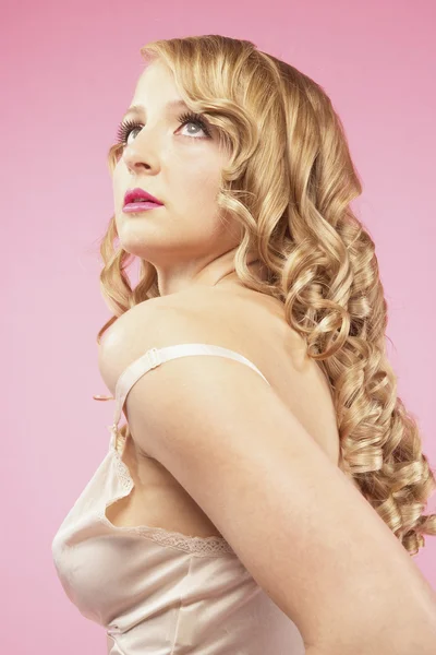 Studio shot of woman with nightgown strap off shoulder