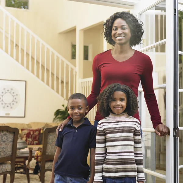 African American mother and children in doorway