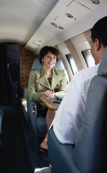 Businesswoman smiling on private airplane