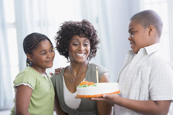 African American mother and children with birthday cake