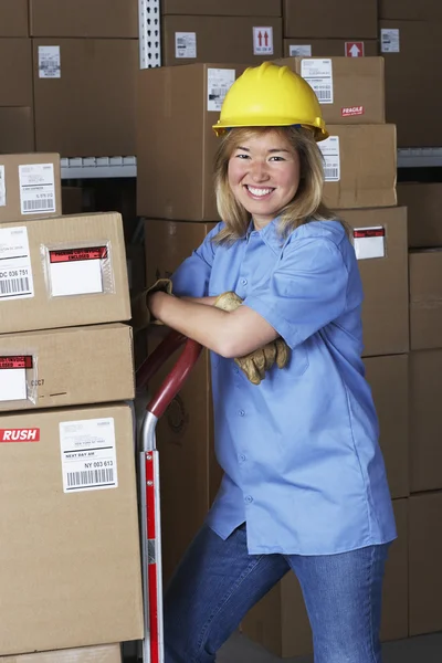 Female warehouse worker with hard hat