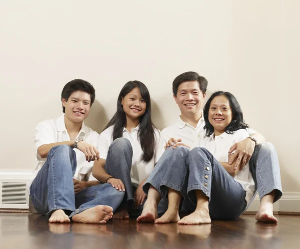 Portrait of Asian family on floor