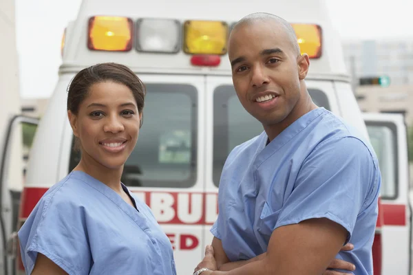 African nurses next to ambulance